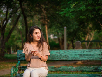 Young woman sitting outdoors