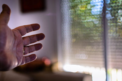 Close-up of cropped hand at home