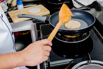 Midsection of man preparing food in kitchen