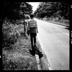 Woman walking on road