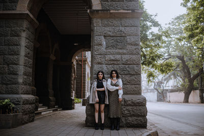 Young couple standing by tree