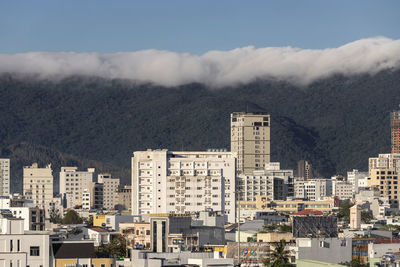 Buildings in city against sky