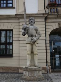 Close-up of statue against building in city