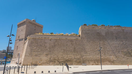 Low angle view of historic building against blue sky