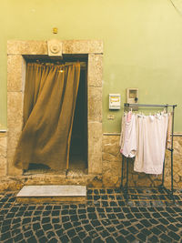 Rear view of woman standing against wall