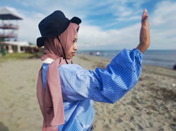 Midsection of woman standing on beach