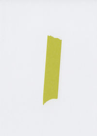 High angle view of yellow paper against white background