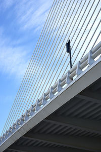 Low angle view of modern bridge against sky