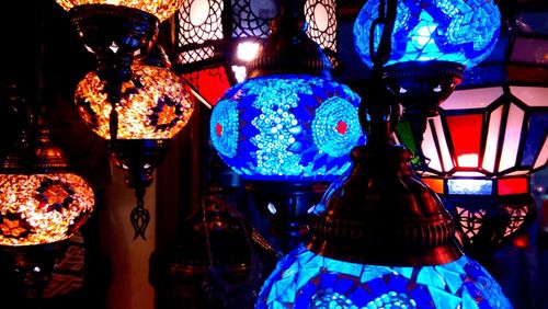 Low angle view of illuminated lanterns hanging on ceiling