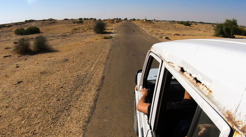 High angle view of people in vehicle on road amidst desert landscape