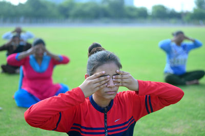 Rear view of people on field