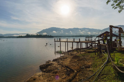 Pier over lake against sky