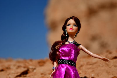 Close-up of young woman standing on sand