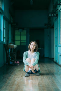 Portrait of woman sitting on floor