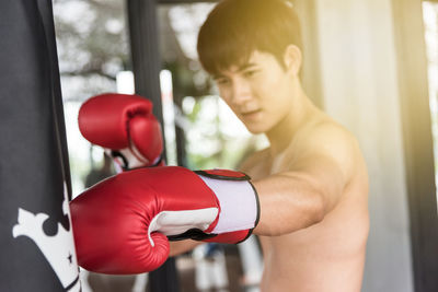 Man practicing boxing on punching bag