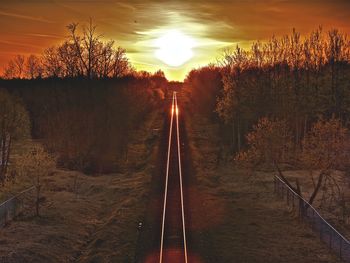 View of railroad tracks at sunset