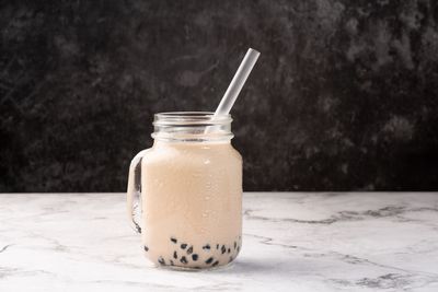 Close-up of drink in glass jar on table