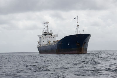 Ship sailing on sea against sky