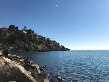 Scenic view of sea against clear blue sky