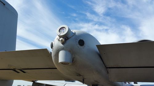 Low angle view of military airplane against sky