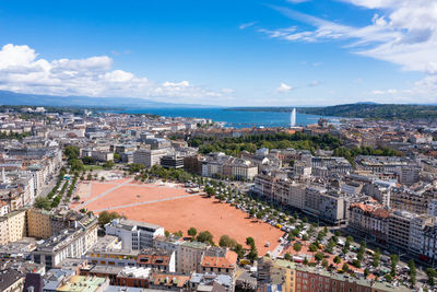 High angle view of townscape by sea against sky