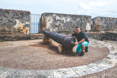 Full length of young man on wall