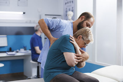 Side view of doctor examining patient at home