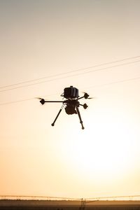 Low angle view of overhead cable car against sky