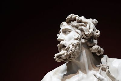 Low angle view of statue against black background