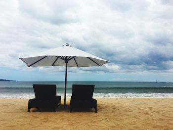 Lifeguard hut on beach against sky