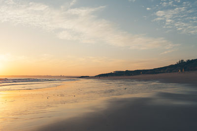 Scenic view of beach against sky during sunset