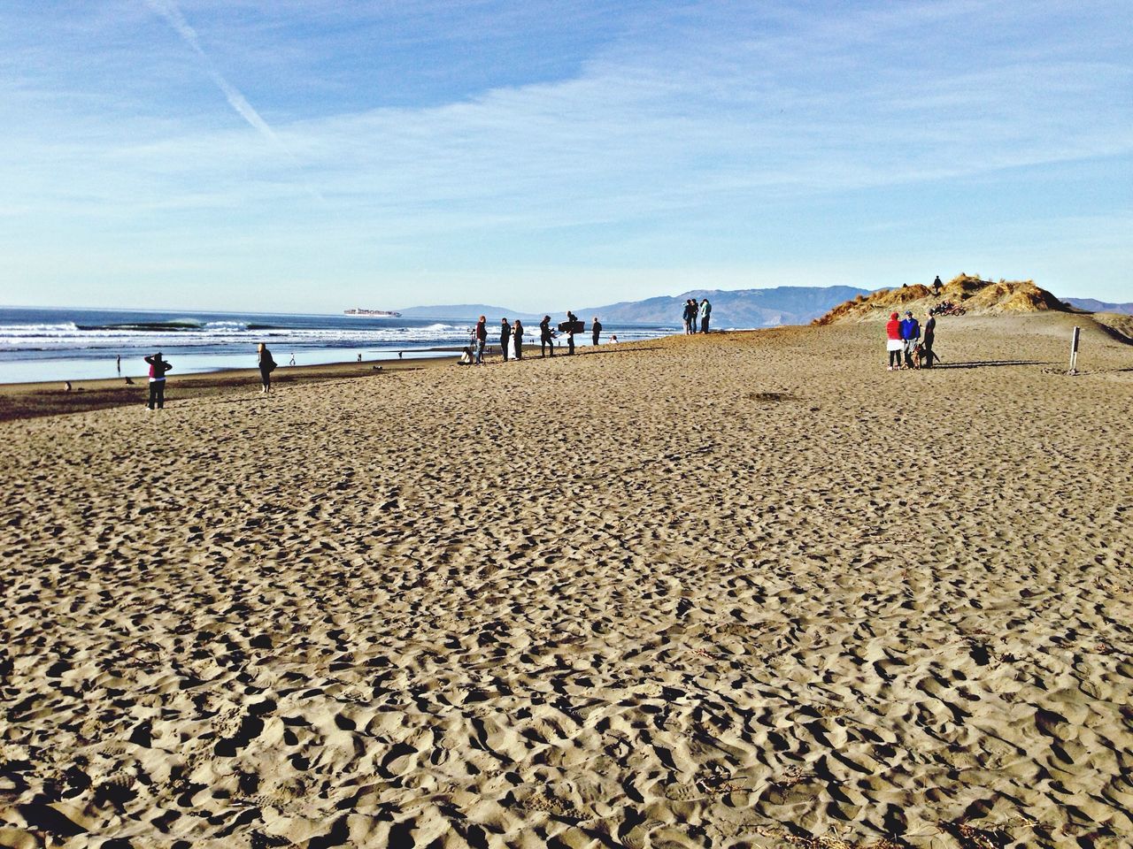 beach, sea, sand, water, shore, sky, tranquil scene, vacations, scenics, incidental people, tranquility, horizon over water, nature, cloud - sky, large group of people, leisure activity, beauty in nature, lifestyles, blue