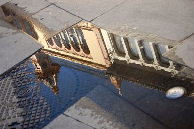 Reflection of building in puddle