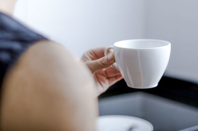 Close-up of hand holding coffee cup