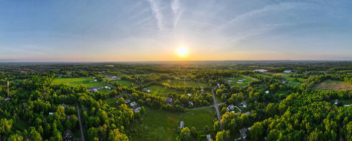 Scenic view of field against sky during sunset