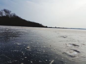 Scenic view of frozen river against sky