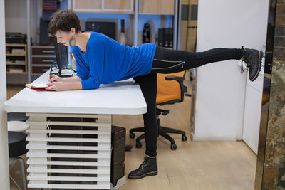 Low section of woman exercising in gym