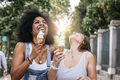 Happy young woman holding ice cream