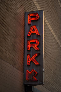 Text on parking sign at night