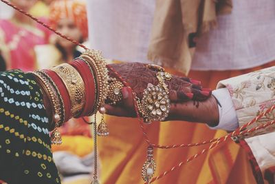 Midsection of couple holding hands