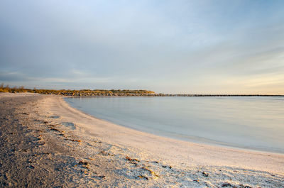 Scenic view of beach against sky during sunset