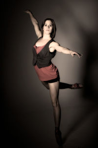 Portrait of young woman jumping over white background