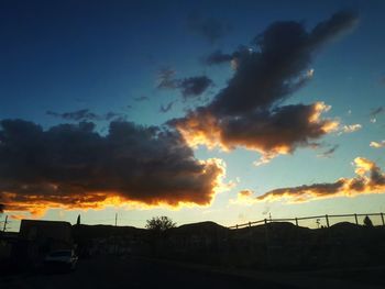 Low angle view of silhouette building against sky during sunset