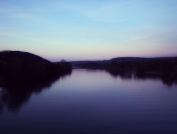 Scenic view of lake against clear sky during sunset