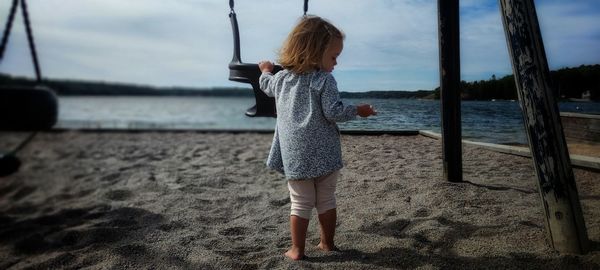 Full length of girl standing at beach