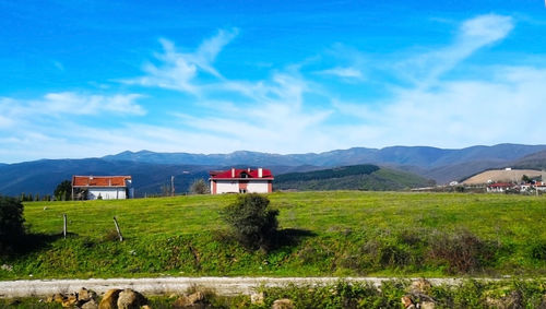 House on field against sky