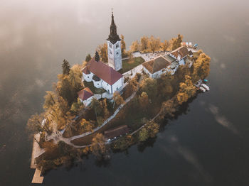 Reflection of tree and building on water