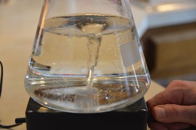 Close-up of hand holding glass of wine