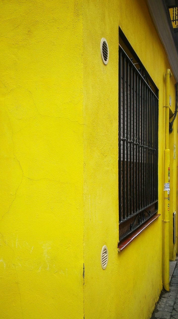 yellow, built structure, architecture, building exterior, closed, door, wall - building feature, house, wall, residential structure, protection, safety, building, outdoors, window, residential building, day, no people, shutter, entrance