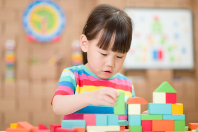 Portrait of cute boy playing with toy on table